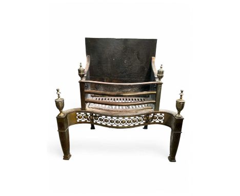 A Regency style polished steel fire grate. 20th century, the serpentine shaped front with pierced frieze, urn finials, and en