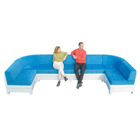 Superyacht furnishings, a large upholstered outdoor seat of curved form.  A contemporary design of white fibreglass with blue