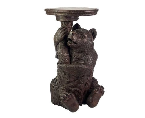 A Black Forest Linden wood carved bear stand. 19th century, with inset glass eyes and supporting a tree trunk mounted with an