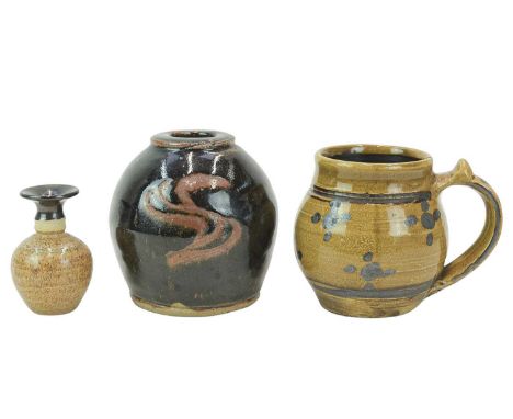 A Seth Cardew Wenford Bridge studio pottery mug. Of bellied form, height 10.5cm, together with a slip glazed studio pottery v