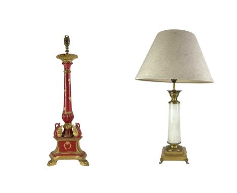 A carved wooden gilt and red painted table lamp. Probably Italian, carved with wreaths and bows, (height 67cm), with another 