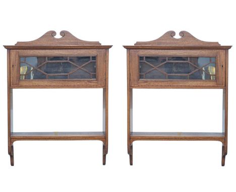 A pair of Edwardian mahogany and inlaid wall cabinets. Each fitted a satinwood banded glazed door above a shelf, height 87cm,