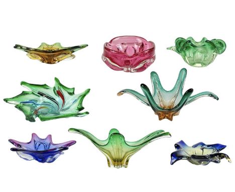 Eight colourful art glass dishes of organic form. Mid 20th century, Italian and Czechoslovakian, the largest measuring 42cm w