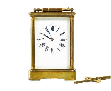 A French brass carriage clock. Striking on a gong, with winding key, height 17cm.