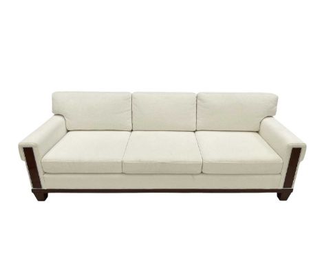 Superyacht furnishings, a contemporary four/five seater sofa with white boucle fabric.  On a highly laquered wood veneered ba