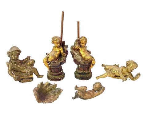 A pair of gilt metal cherub lamp bases. Circa 1900, each upon a plaster shell, height 30cm, together with three other gilt me
