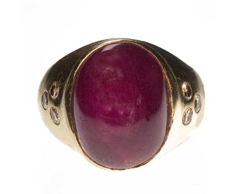 A RUBY AND DIAMOND DOMED RING the cabochon ruby in a rubover setting, each shoulder set with three round brilliant-cut diamon