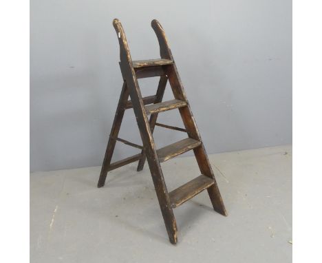 A vintage stained pine step ladder. Height 114cm (deployed).