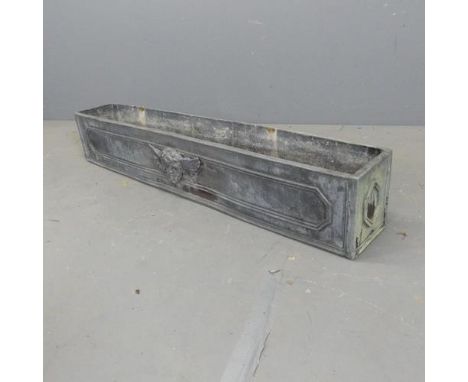 A rectangular lead planter, with cherub decoration. W121cm, H21cm, D20cm.