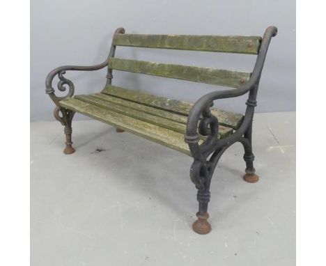An antique teak slatted child's garden bench with painted cast iron ends. W86cm, H58cm, D47cm.