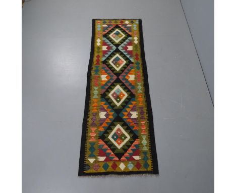 A black ground Maimana kilim runner, 211x71cm.