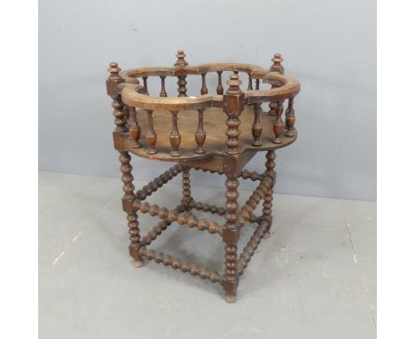 An antique oak plant stand with bobbin turned supports and galleried top. Width 66cm, height 81cm.