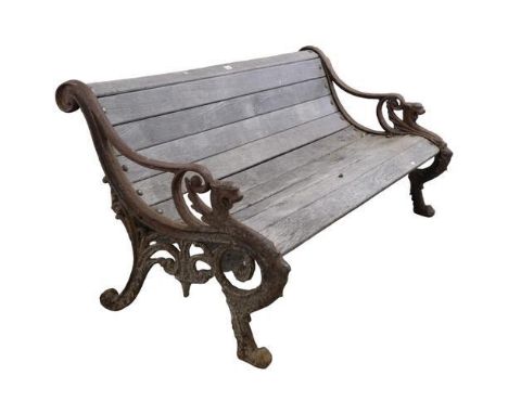 A teak slatted garden bench, with heavy Georgian style cast iron ends. 158x73x80cm.Good overall condition. Probably dating to