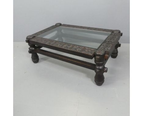 A rectangular carved-oak coffee table, with inset glass top and celtic knot decoration. Length 98cm, height 35cm, width 68cm.