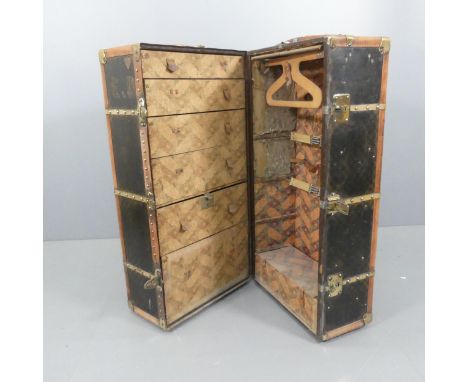 MOYNAT - An early 20th century French travelling wardrobe trunk, the outside featuring the maker's label and bound in brass a