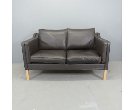 A modern Danish style leather upholstered two-seater sofa. Overall length 142cm, height 84cm, depth 83cm.