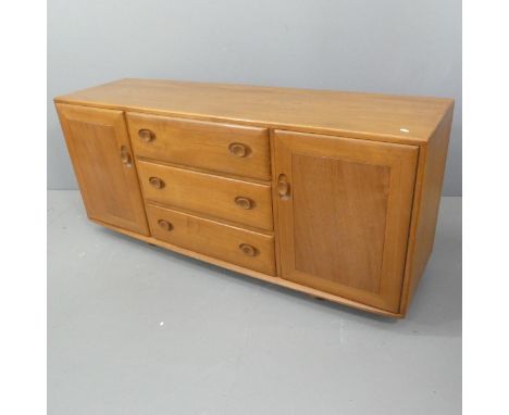 ERCOL - A model 455 Windsor sideboard, with three drawers between two cupboards and maker's mark. Length 156cm, height 69cm, 
