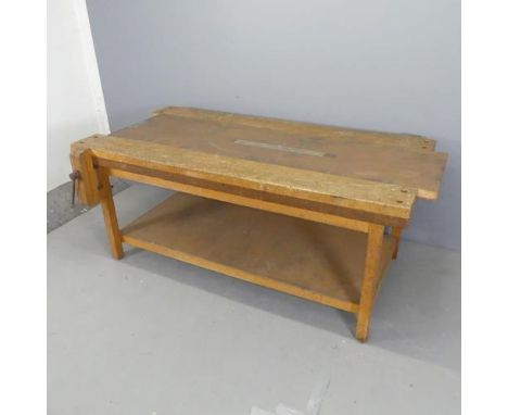 A vintage Japanese two-tier work bench, with sliding metal topped centre panel and fitted vice. W180cm, H77cm, D105cm.Good us