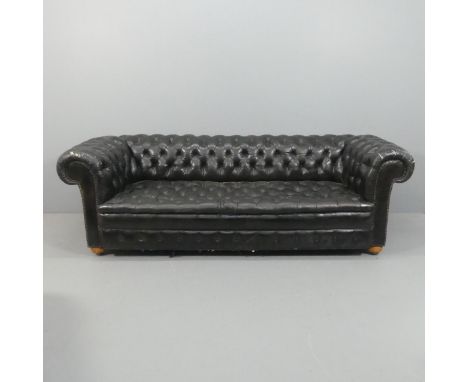 An vintage black leather Chesterfield style sofa. Overall 230x75x95cm, seat 163x42x60cm.Some crackling to leather, particular