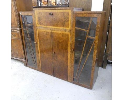 A modern Art Deco style burr walnut veneered drinks cabinet. W133cm, H114cm, D40cm.When open, upper central compartment exten