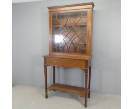 An Edwardian cross-banded mahogany and satinwood strung two-section bookcase on stand, with lattice glazed drawer, single dra