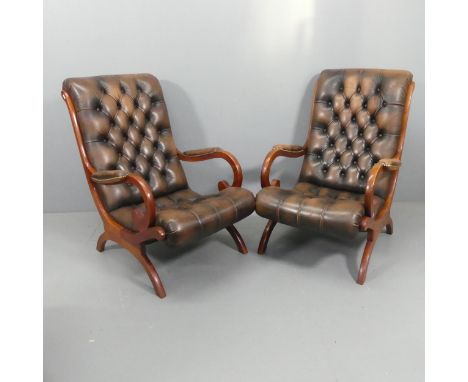 A pair of teak and button-back leather upholstered Chesterfield slipper / fauteuil chairs.