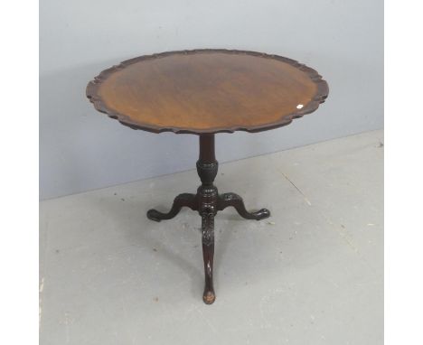 A reproduction mahogany circular occasional table, with piecrust edge, turned central column and tripod base. Diameter 76cm, 