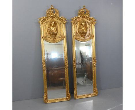 A pair of Italian Baroque design gilt painted wall mirrors, with bevel edged glass and decorated with foilate pediments and f