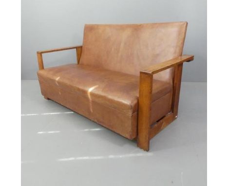 W H “Curly” Russell for Gordon Russell, a 1930s modernist sofa, the oak frame with leather upholstery. Overall W153cm, H82cm,