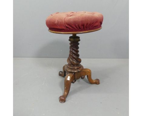 A 19th century rosewood piano stool, with rise and fall mechanism, raised on a spiral turned support with tripod base. Height