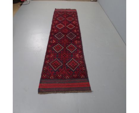 A red ground Meshwani runner, 257 x 65cm