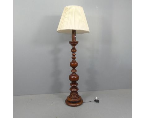 A Continental turned mahogany standard lamp with silk shade. Height to bayonet 145cm.