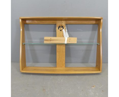 ERCOL - A light elm hanging shelf with swan design. Overall width 92cm, height 62cm, depth 18cm.