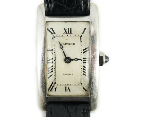 A mid 20th century 18ct white gold Cartier Tank Americane manual wind wrist watch, with rectangular Roman dial and facetted s