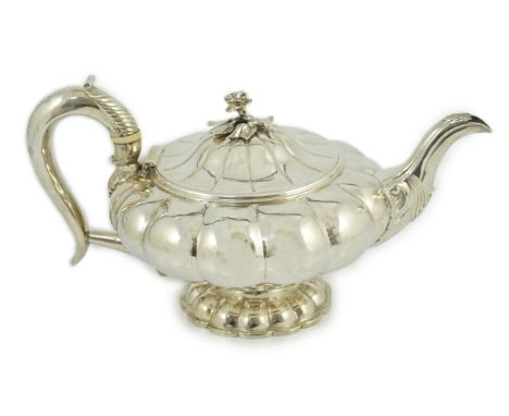 A George IV silver melon shaped pedestal teapot, by Joseph Angell I, with rose finial, on lobed foot, London, 1825, length 28