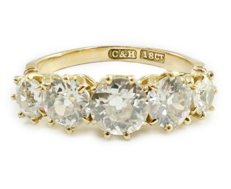 An 18ct gold and graduated five stone diamond set half hoop ring, the total diamond weight approximately estimated as 2.00ct,