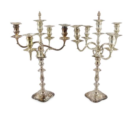 A good pair of George V silver four branch five light candelabra, by Elkington &amp; Co., with waisted knopped stems and acan