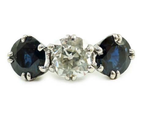 A white gold, sapphire and diamond set three stone ring, central stone approximately 1.4ct the diamond weighing approximately