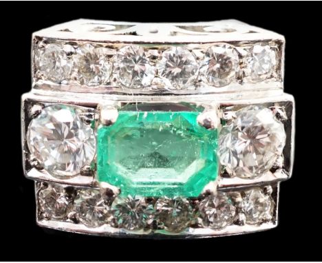 A Swedish 18k gold, single stone emerald and fourteen stone diamond set three row cluster ring, the emerald measuring 5.8mm b