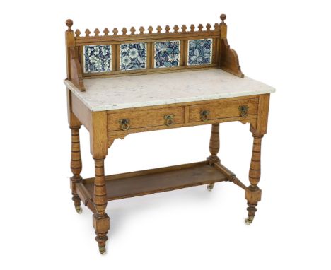 Lewis Foreman Day (1845-1910). A Victorian Aesthetic movement golden oak and marble washstand, inset with four ceramic tiles 