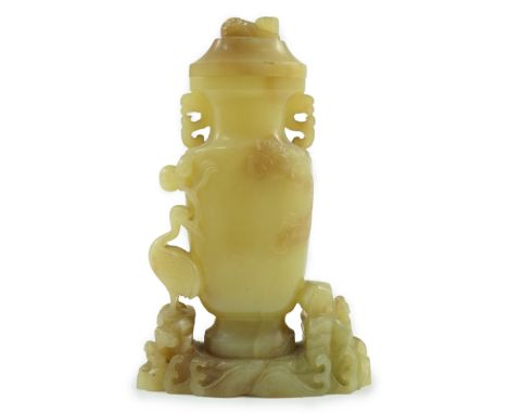 A Chinese yellow and russet jade vase and cover, 19th/20th century, of flattened baluster shape, carved in relief and open wo