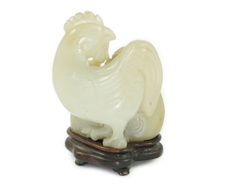 A Chinese pale celadon jade chicken group, 19th century, the hen and the cockerel both grasping a sprig of millet in their be