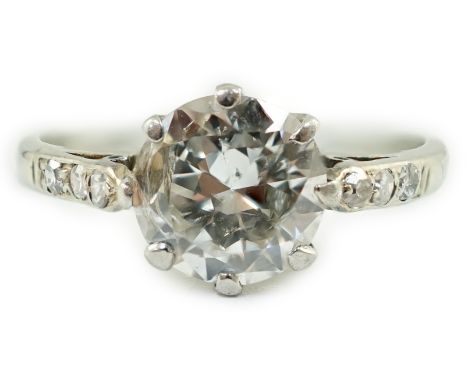 A platinum and single stone diamond ring, with diamond set shoulders, the central stone weighing approximately 1.33ct, with a