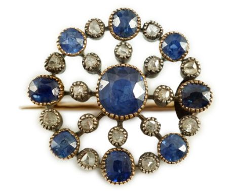 A Belle Epoque gold and silver, sapphire and diamond cluster set circular brooch, with a millegrain setting, the central sapp