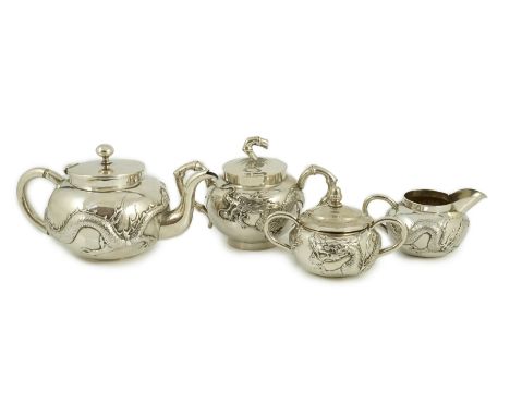 A Chinese three piece silver bachelor's tea set, by TC, decorated with dragon and one other similar Chinese silver two handle