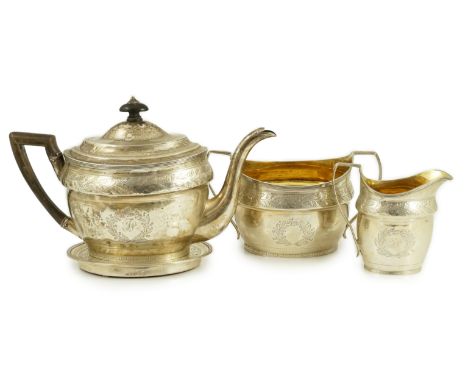 A George III Scottish chased silver oval three piece tea set and teapot stand, by William &amp; Patrick Cunningham, with engr