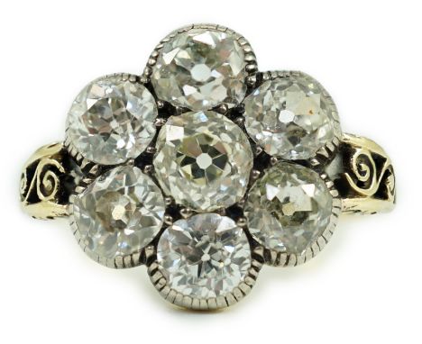 A late 19th/early 20th century gold and collet set seven stone old round cut diamond flower head cluster ring, total diamond 