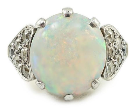 An 18ct gold and single stone white opal set ring, with twelve stone diamond set shoulders, size N, gross weight 6.1 grams.**