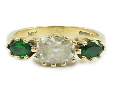 A modern 18ct gold, diamond and green tourmaline set three stone ring, size N, gross 4.1 grams.***CONDITION REPORT***Some min