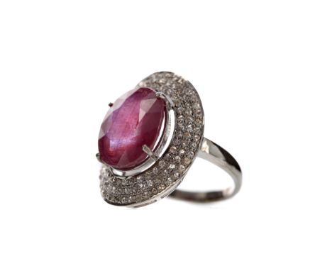 RUBY AND DIAMOND RING, set with a faceted ruby of approximately 9.60 carats, within a halo of rose cut diamonds totalling app